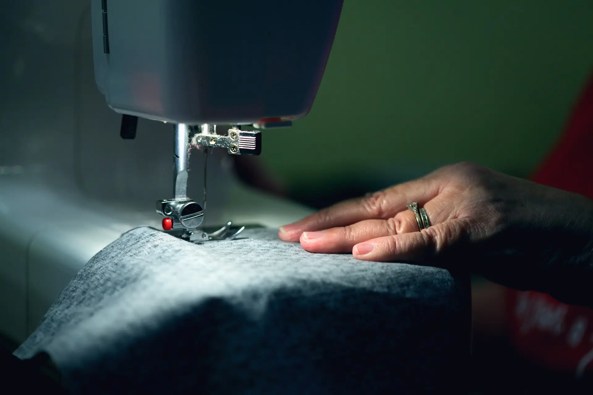 Upholsterer stitching fabric on a sewing machine Lee Verity Upholstery Wakefield